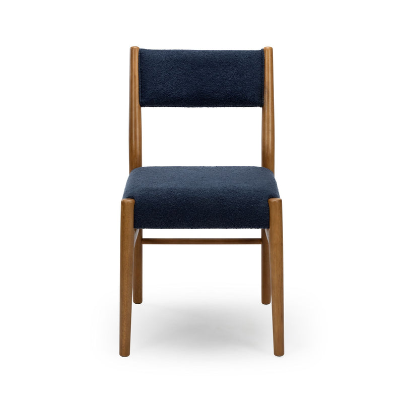 Front view of a navy upholstered dining chair with light wooden frame on a white background