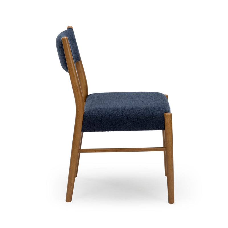 Mid-century modern wooden dining chair with navy blue upholstered seat and backrest, side view on white background