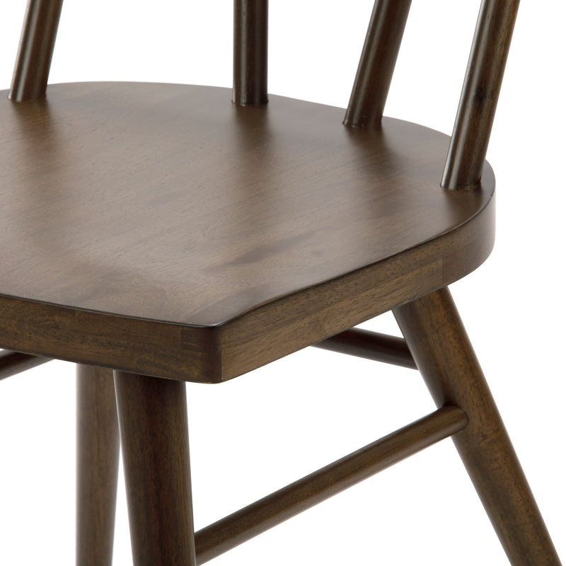Close-up of dark brown wooden bar stool seat and spindle back showing round seat, tapered legs and crossbar stretchers