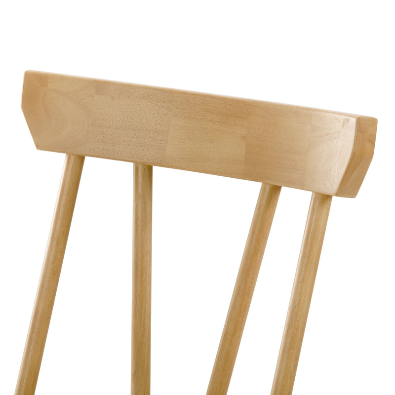 Close-up of light oak wooden spindle-back dining chair showing smooth natural wood grain and finish