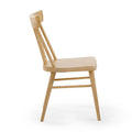 Minimalist Scandinavian beech wood dining chair, natural finish, side view showing curved ergonomic backrest and tapered spindle legs