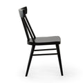 Side view of a black wooden spindle-back dining chair with matte finish, isolated on a white background.
