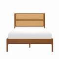 Mid-century modern walnut bed frame with woven cane headboard and white mattress, front view
