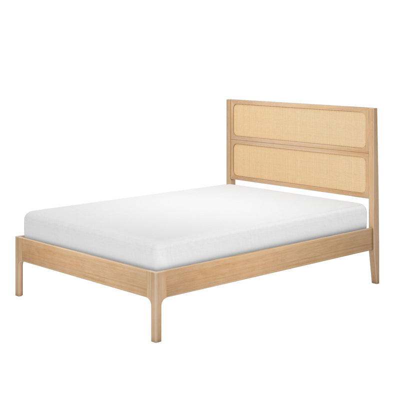 Natural oak wood platform bed frame with woven cane rattan headboard and white mattress, modern Scandinavian minimalist bedroom furniture