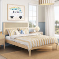 Coastal kids bedroom with light wood platform bed and rattan headboard, yellow-striped bedding, surf-van wall art, bedside lamp and palm-tree window view