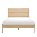 Natural oak platform bed with woven cane rattan headboard and white mattress, front view — minimalist boho bedroom furniture