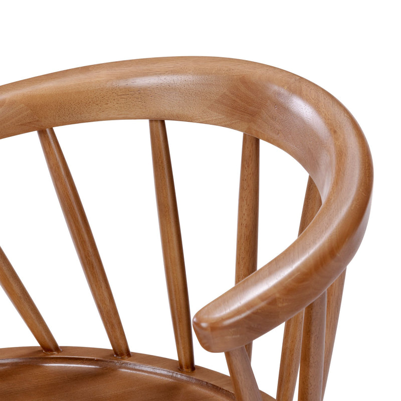 Close-up of a mid-century modern wooden Windsor chair back with curved oak armrest and vertical spindles, smooth natural wood finish