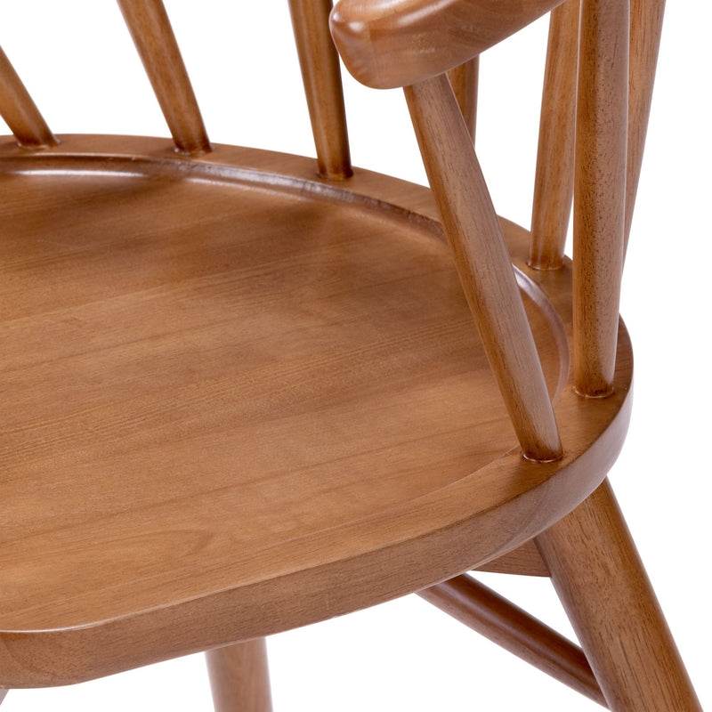 Close-up of a solid wood dining chair seat and spindle back in honey oak finish, polished mid-century modern design