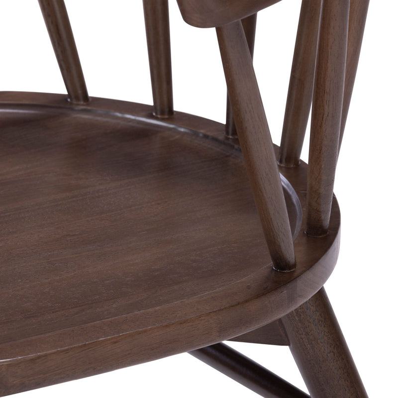 Close-up of brown stained solid wood dining chair seat and spindle-back detail with mid-century modern finish
