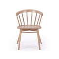 Light natural wood spindle-back dining chair with curved top rail, contoured seat and splayed legs on white background