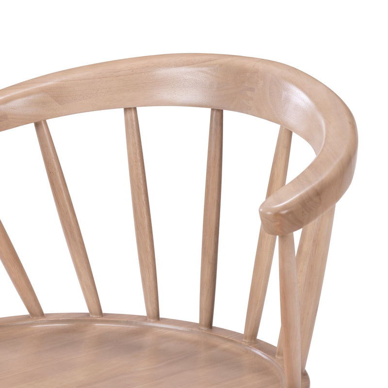 Close-up of curved spindle-back wooden dining chair with smooth natural light wood finish and rounded armrest, Scandinavian modern style
