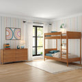 Children's bedroom with wooden bunk beds, colorful vertical striped wallpaper, midcentury wooden dresser, white curtains and black-framed window — bright modern kids' room decor