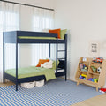 Modern navy metal bunk bed with green bedding and orange pillows in a bright kids' bedroom featuring a toy shelf, soccer ball and blue striped rug under sheer white curtains