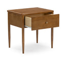 Mid-century modern walnut bedside table with single open drawer, tapered legs and brass knob