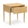 Light wood mid-century modern nightstand bedside table with a single partially open drawer and tapered legs, minimalist wooden side table