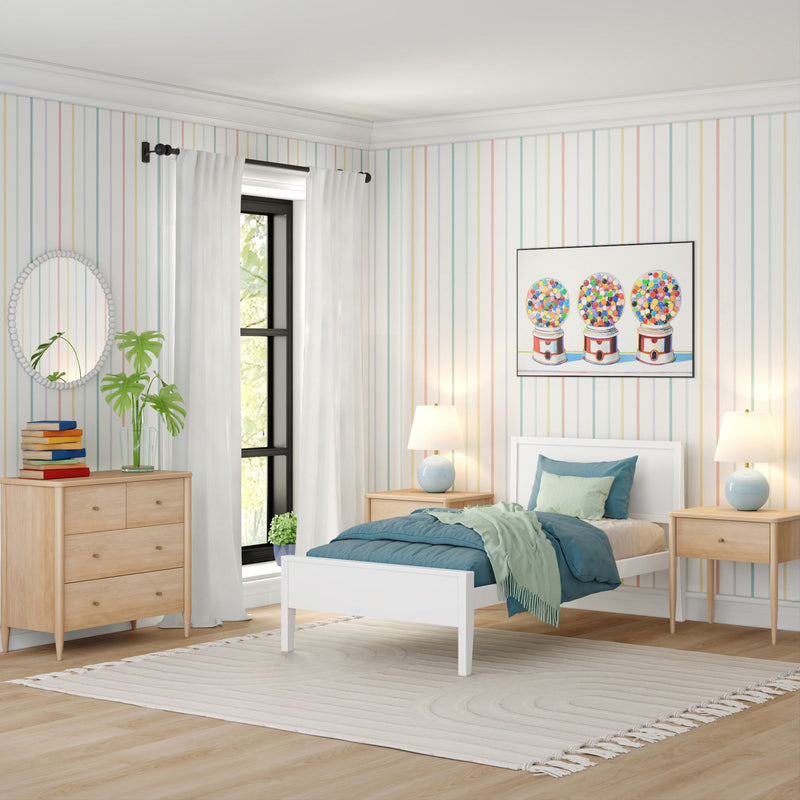 Modern kids bedroom with white twin bed, teal bedding, pastel vertical striped wallpaper, gumball machine wall art, matching light wood nightstands and dresser, large black‑framed window with white curtains and neutral area rug