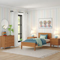 Mid-century modern children's bedroom with wooden bed and nightstands, blue bedding, pastel striped wallpaper, gumball machine wall art and white curtains