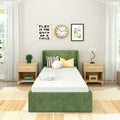 Modern kids bedroom with green upholstered twin bed, light wood nightstands, patterned pillows, wall clock and "Play is the Work of a Child" wall art