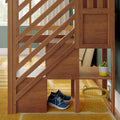 Wooden loft bed with diagonal railing and built-in under-bed storage, blue sneakers and yellow wire basket on mustard rug, potted succulent on shelf