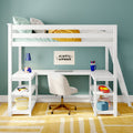 White children's loft bed with built-in L-shaped desk and shelves, swivel chair, laptop, blue desk lamp, striped pillows and yellow blanket against a teal wall, kids' study area