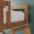 Close-up of solid wood bunk bed ladder and side rail in natural oak finish with white bedding against teal wall