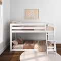 White wooden bunk bed in a neutral nursery with pink-beige gingham bedding, plush pillows and framed daisy wall art