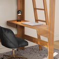 Minimalist home office workspace with wall-mounted natural wood desk, closed silver laptop, black globe desk lamp and ergonomic black swivel chair