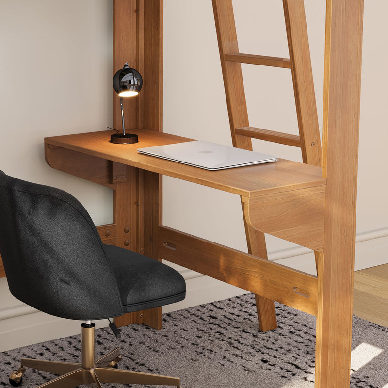 Minimalist home office workspace with wall-mounted natural wood desk, closed silver laptop, black globe desk lamp and ergonomic black swivel chair