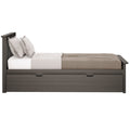 Dark gray wooden platform bed with built-in under-bed storage drawer, neutral beige bedding and striped pillows, modern farmhouse style
